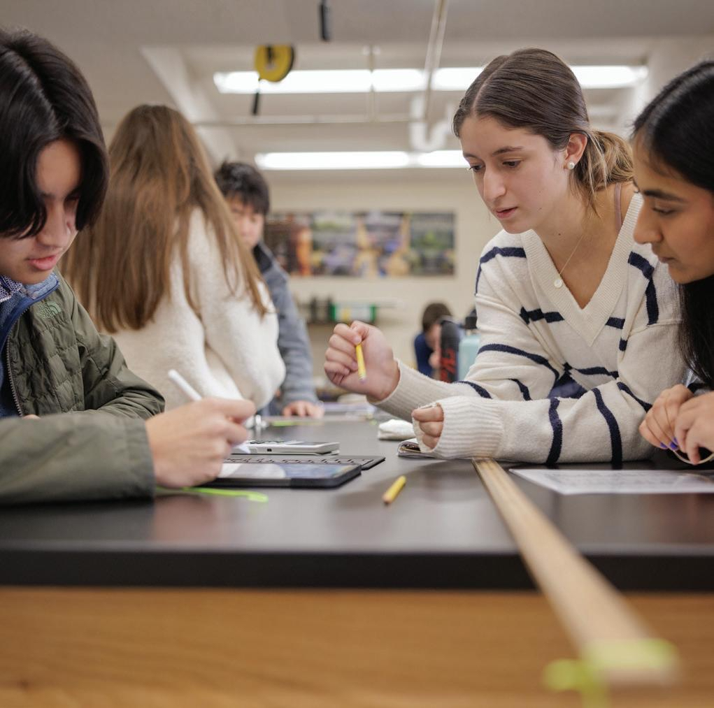Students working together at a lab table in a classroom