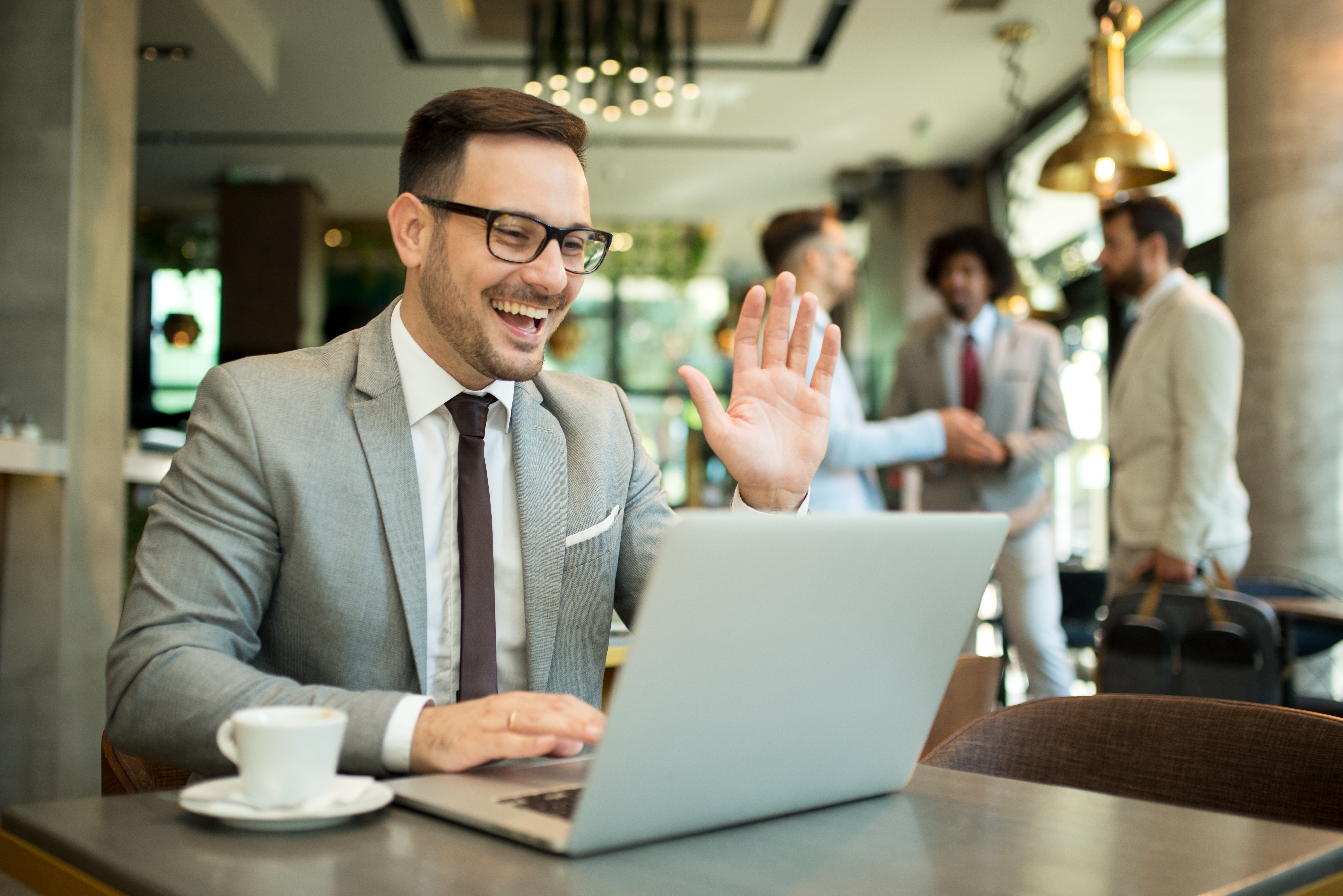 Professional waving during a video interview